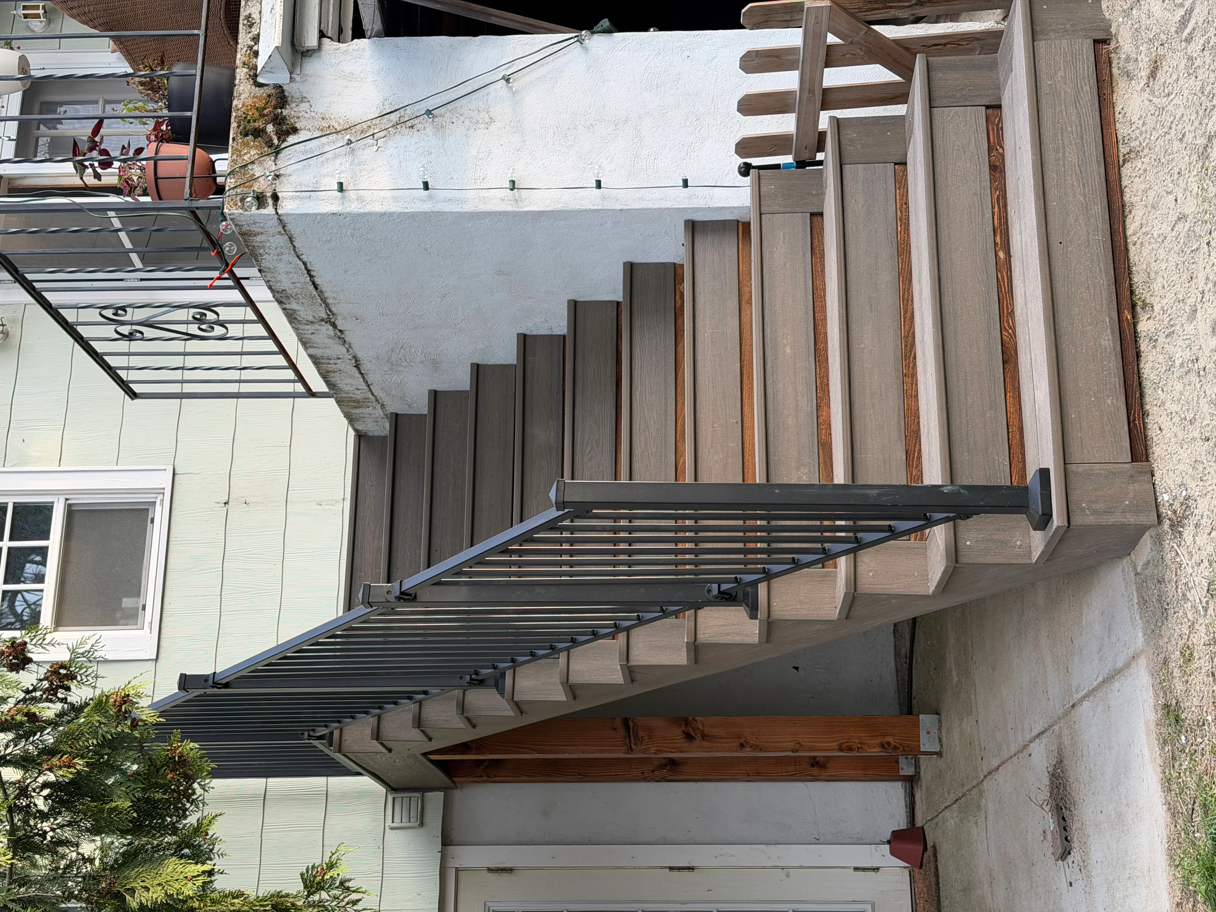 Multi-level composite deck with metal pergola and horizontal slat shade structure