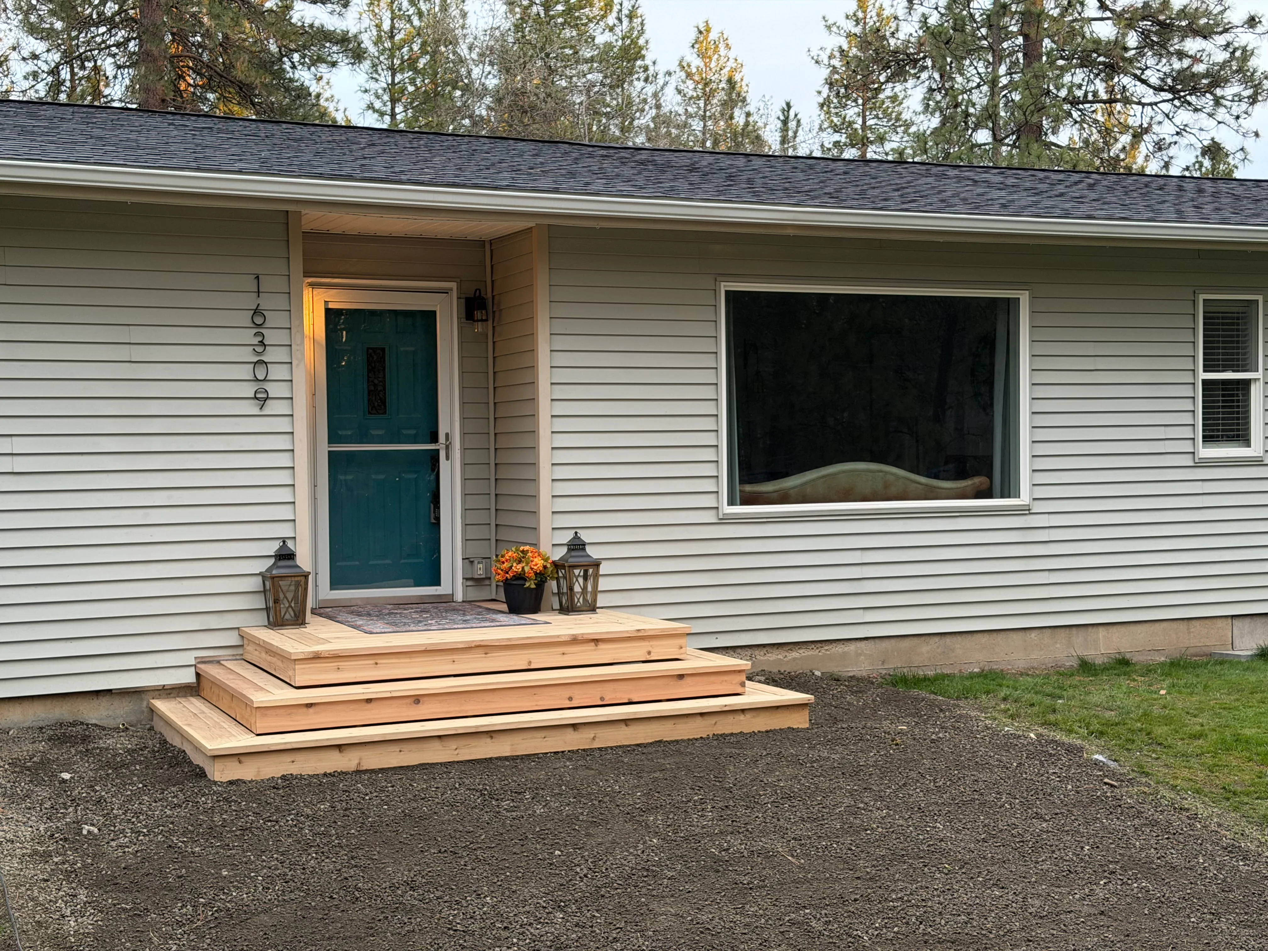 Multi-level cedar wood deck with tiered steps at residential home entry